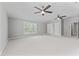 Large bonus room with carpet, ceiling fans, and natural light at 5424 Westminster Ln, Fuquay Varina, NC 27526