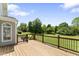 Lovely wood deck overlooking a spacious green backyard with mature trees on a sunny day at 5424 Westminster Ln, Fuquay Varina, NC 27526