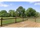 Wood deck overlooking a green lawn and wooded area on a sunny day at 5424 Westminster Ln, Fuquay Varina, NC 27526