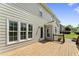Spacious wood deck on the back of the home with multiple windows and an outdoor light at 5424 Westminster Ln, Fuquay Varina, NC 27526