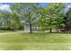 Beautiful two-story home with attached garage and a lush green lawn surrounded by mature trees at 5424 Westminster Ln, Fuquay Varina, NC 27526