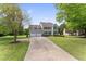 Charming two-story home with a two-car garage, well-maintained lawn, and a long driveway at 5424 Westminster Ln, Fuquay Varina, NC 27526