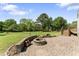 Stone fire pit with seating area and a lush green lawn on a sunny day at 5424 Westminster Ln, Fuquay Varina, NC 27526