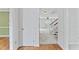 View of the foyer with hardwood floors, a white door, and an open view to the living room and staircase at 5424 Westminster Ln, Fuquay Varina, NC 27526