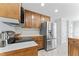 Kitchen featuring stainless steel refrigerator, wooden cabinets, and electric stovetop at 5424 Westminster Ln, Fuquay Varina, NC 27526