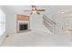 Spacious living room with brick fireplace, neutral carpet, staircase, and entryway views at 5424 Westminster Ln, Fuquay Varina, NC 27526