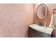 Stylish powder room with a decorative mirror, granite countertop, and a modern dark wood vanity cabinet at 5424 Westminster Ln, Fuquay Varina, NC 27526