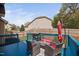 Inviting back deck featuring a grill, dining set, umbrella, and blue floor perfect for outdoor gatherings at 556 Rolling Meadows Dr, Clayton, NC 27527