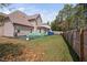 Expansive backyard featuring a fence, garden beds, and lawn, perfect for outdoor activities and relaxation at 556 Rolling Meadows Dr, Clayton, NC 27527