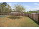 Large backyard with a privacy fence and a tree perfect for outdoor activities and relaxation at 556 Rolling Meadows Dr, Clayton, NC 27527
