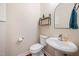 Charming powder room with pedestal sink and modern fixtures and stylish decor at 556 Rolling Meadows Dr, Clayton, NC 27527