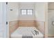 Elegant bathroom featuring a luxurious soaking tub and tiled walls at 556 Rolling Meadows Dr, Clayton, NC 27527