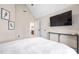 Neutral bedroom featuring vaulted ceilings, a large flatscreen television, and an ensuite bathroom at 556 Rolling Meadows Dr, Clayton, NC 27527