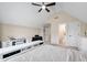 Bright bedroom featuring a work area, keyboard, ceiling fan, and an ensuite bathroom at 556 Rolling Meadows Dr, Clayton, NC 27527