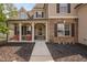 Inviting front porch featuring decorative columns and red chairs at 556 Rolling Meadows Dr, Clayton, NC 27527
