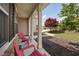 Inviting front porch featuring decorative columns and red chairs at 556 Rolling Meadows Dr, Clayton, NC 27527