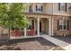 Inviting front porch featuring decorative columns and red chairs at 556 Rolling Meadows Dr, Clayton, NC 27527