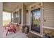 Inviting front porch featuring decorative columns and red chairs at 556 Rolling Meadows Dr, Clayton, NC 27527
