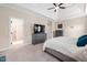 Spacious primary bedroom features tray ceiling, ceiling fan, and soft carpet flooring at 556 Rolling Meadows Dr, Clayton, NC 27527