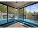 Enclosed sunroom featuring a blue deck, outdoor seating, and a barbecue grill at 556 Rolling Meadows Dr, Clayton, NC 27527