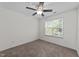 Comfortable bedroom featuring neutral walls, carpeted floor, a ceiling fan, and a window overlooking the outdoors at 5702 Cameo Glass Way, Raleigh, NC 27612