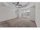 Spacious bedroom with large windows providing lots of natural light and a ceiling fan for added comfort at 5702 Cameo Glass Way, Raleigh, NC 27612