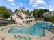 Stunning community pool featuring ample seating, resort-style umbrellas, and an attractive clubhouse at 5702 Cameo Glass Way, Raleigh, NC 27612
