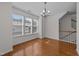Sunlit dining room showcasing hardwood floors, a contemporary chandelier, and views of the neighborhood at 5702 Cameo Glass Way, Raleigh, NC 27612