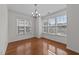 Bright dining room featuring hardwood floors, a modern chandelier, and an abundance of natural light at 5702 Cameo Glass Way, Raleigh, NC 27612