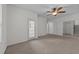 Living room featuring neutral walls, carpeted floor, a ceiling fan, and doors leading to other rooms of the house at 5702 Cameo Glass Way, Raleigh, NC 27612