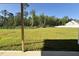 Patio overlooking large grassy backyard with wooded boundary at 58 Heatherglenn Cir, Princeton, NC 27569