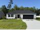 Traditional ranch style home featuring a well-manicured lawn and a two-car garage at 58 Heatherglenn Cir, Princeton, NC 27569