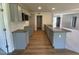 Modern kitchen featuring granite countertops, wood flooring, and gray cabinets at 58 Heatherglenn Cir, Princeton, NC 27569