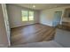 Cozy living room featuring wood floors, kitchen view, and natural light from windows at 58 Heatherglenn Cir, Princeton, NC 27569