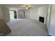 Open-concept living room featuring neutral walls, fireplace, and a front door at 58 Heatherglenn Cir, Princeton, NC 27569