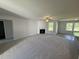 Spacious living room with a fireplace, fan, and large windows at 58 Heatherglenn Cir, Princeton, NC 27569