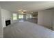Inviting living room showing a fireplace, windows, kitchen, and an open layout at 58 Heatherglenn Cir, Princeton, NC 27569