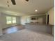Comfortable living room featuring kitchen, wood floors, and natural light from windows at 58 Heatherglenn Cir, Princeton, NC 27569