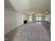 Bright living room with a fireplace, fan, large windows, and a kitchen view at 58 Heatherglenn Cir, Princeton, NC 27569
