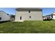 Backyard with a new construction home and green grass on a sunny day at 61 Heatherglenn Cir, Princeton, NC 27569