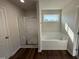 Bright bathroom featuring a shower, soaking tub and a window bringing in natural light at 61 Heatherglenn Cir, Princeton, NC 27569