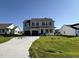 Beautiful two-story home with a spacious driveway and neatly landscaped front yard under a clear blue sky at 61 Heatherglenn Cir, Princeton, NC 27569