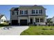 Charming two-story home featuring a spacious two-car garage and a well-manicured front lawn at 61 Heatherglenn Cir, Princeton, NC 27569