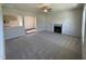 Open-concept living room with fireplace and views into the kitchen and dining area at 61 Heatherglenn Cir, Princeton, NC 27569