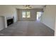 Bright living room features a cozy fireplace, neutral carpet, and natural light from the windows at 61 Heatherglenn Cir, Princeton, NC 27569
