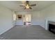 Comfortable living room featuring carpet and a fireplace, with a view into the kitchen at 61 Heatherglenn Cir, Princeton, NC 27569