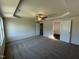 Generous primary bedroom with a tray ceiling, plush carpeting, and ensuite bathroom access at 61 Heatherglenn Cir, Princeton, NC 27569