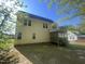 Back exterior view of home showing a screened porch and a spacious backyard at 66 Saddle Ln, Lillington, NC 27546