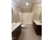 Bathroom features a double sink vanity and a shower-tub combo at 66 Saddle Ln, Lillington, NC 27546