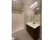 Bright bathroom with a vanity and a shower-tub combo at 66 Saddle Ln, Lillington, NC 27546